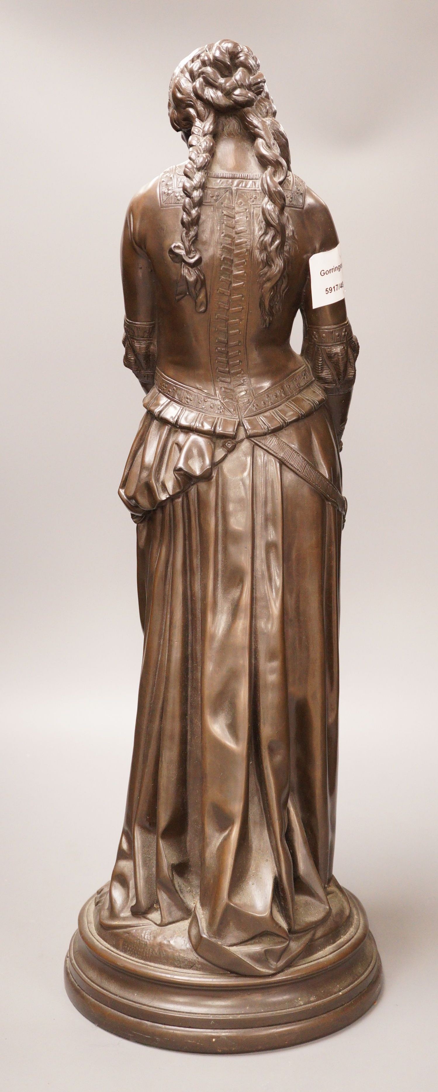 After Boisseau, a tall bronzed metal figure of a standing maiden, signed to verso, 58cm tall